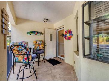 Charming front porch with comfortable seating, perfect for enjoying the outdoors at 507 Pine Hollow Cir # 507, Englewood, FL 34223