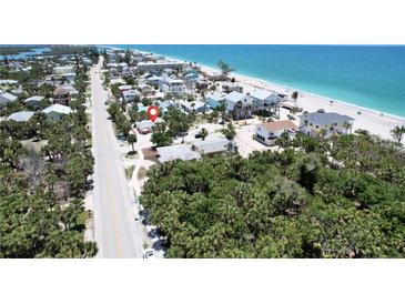 Gorgeous aerial view of the home and surrounding neighborhood near the sandy beach and the Gulf of Mexico at 95 Coquina Ln, Englewood, FL 34223