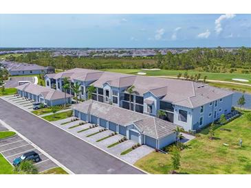New condos featuring attached garages, lush landscaping, golf course view, and a modern neutral color scheme at 12470 Wellen Golf St # 108, Venice, FL 34293