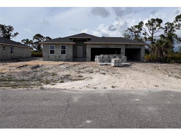 New construction home with a spacious three car garage and block construction at 14 Current Ln, Placida, FL 33946