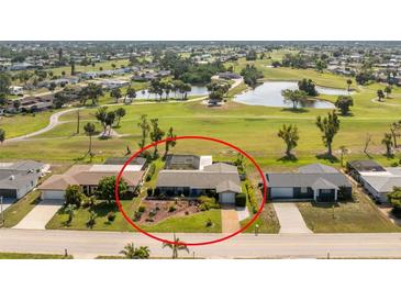 Charming single-story home with a screened lanai, lush landscaping and access to a golf course and pond at 146 Rotonda Cir, Rotonda West, FL 33947