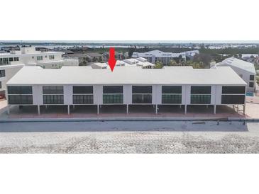 Bright, modern beach condominium complex with a metal roof and impact-resistant windows at 2700 N Beach Rd # B205, Englewood, FL 34223