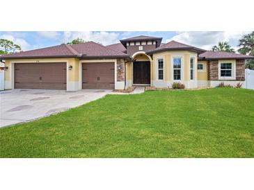 Charming home featuring a well-maintained lawn and a two-car garage at 2758 Morrietta Ln, North Port, FL 34286