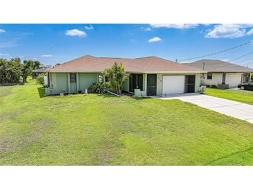 Charming single-story home with a well-maintained lawn and attached garage at 279 Mark Twain Ln, Rotonda West, FL 33947