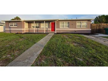 Charming single-story home with a red front door and a walkway leading to the entrance at 3157 Crestwood Dr, Port Charlotte, FL 33952