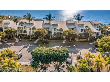 Beautiful condominiums with lush landscaping, an inviting driveway, and peekaboo ocean views at 5000 Gasparilla Rd # 8B, Boca Grande, FL 33921