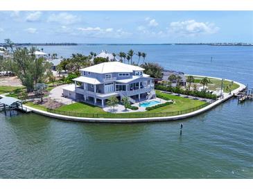 Stunning waterfront home with a private pool and dock, nestled on a peninsula with panoramic water views at 565 Green Dolphin S Dr, Placida, FL 33946