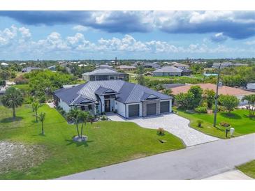 Wide aerial view of a single-Gathering home with dark roof, manicured lawn, and a three car garage at 9532 Miami Cir, Port Charlotte, FL 33981