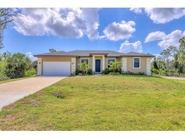Well maintained, single-story home with a two car garage and a freshly manicured lawn at 10242 Hallendale Dr, Port Charlotte, FL 33981