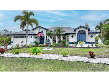 Charming single-Gathering home with a well-manicured lawn, mature palm trees and fountain at 13703 Drysdale Ave, Port Charlotte, FL 33981