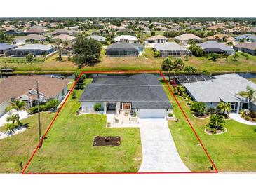 Beautiful single Gathering home with a well-manicured lawn outlined in red, a long drive way, and lovely landscaping at 209 Fairway Rd, Rotonda West, FL 33947
