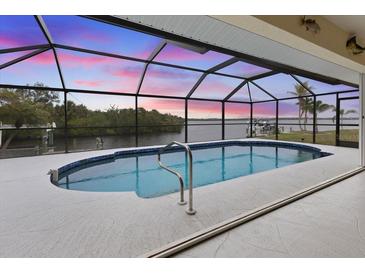 Screened pool offers a stunning waterfront view and a private area for relaxation and entertainment at 2295 Chilcote Ter, Port Charlotte, FL 33981