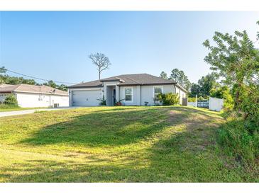 Charming single-story home with a well-manicured lawn and inviting curb appeal at 2408 Bonanza Ln, North Port, FL 34286