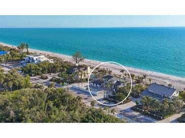 Breathtaking aerial view of a beachfront home with lush landscaping and stunning ocean views at 8500 Manasota Key Rd, Englewood, FL 34223