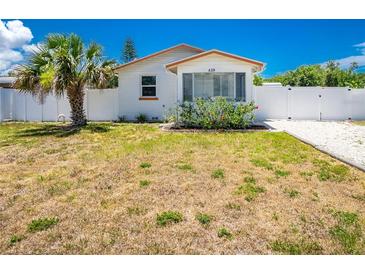 Charming single-story home with a well-maintained yard and a white fence, creating a cozy curb appeal at 859 E 2Nd St, Englewood, FL 34223