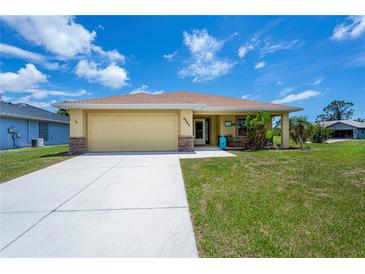 Charming single-story home featuring an attached garage and well-maintained lawn at 9325 Crugar Ter, Englewood, FL 34224