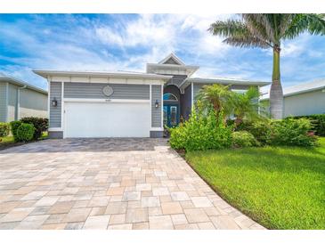 Charming single Gathering home with a well manicured lawn and brick driveway at 10487 Coquina Ct, Placida, FL 33946
