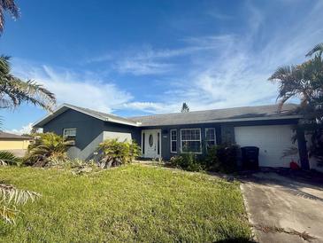 Charming single-story home with a well-manicured lawn and attached garage at 133 Paddington Rd, Venice, FL 34293