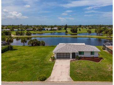 Beautiful waterfront home with mature landscaping and views of a scenic lake and golf course at 15 Oakland Hills Pl, Rotonda West, FL 33947