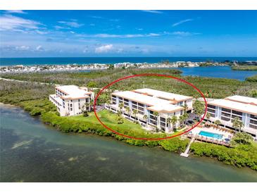 Beautiful waterfront condos featuring pristine landscaping, lush greenery, and waterfront access at 1701 Beach Rd # 207, Englewood, FL 34223