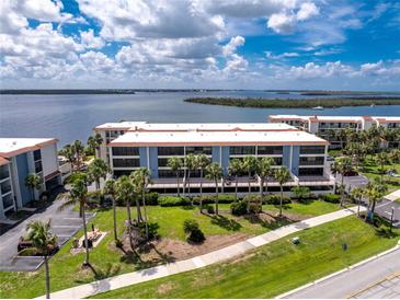 Stunning waterfront condo complex boasting lush landscaping and picturesque water views at 1701 Beach Rd # 207, Englewood, FL 34223