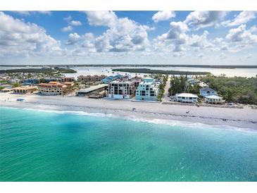 Beautiful aerial view of the beach and beachfront condos with clear turquoise water at 50 Meredith Dr # 9, Englewood, FL 34223