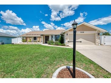 Charming single-story home with well-manicured lawn and stone accents, offering a welcoming curb appeal at 7218 Darlington St, Englewood, FL 34224