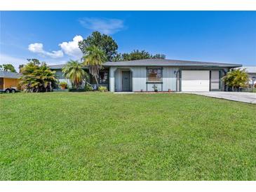 Charming single-story home featuring a well-maintained lawn and attached two-car garage at 7104 Castilla St, Port Charlotte, FL 33981