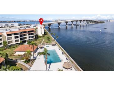 Aerial view of waterfront property with pool and bridge at 103 1St E St # 204, St Petersburg, FL 33715