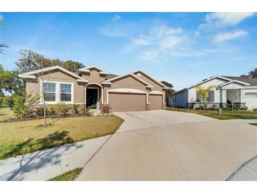 Lovely single story home featuring a well maintained lawn and attached two car garage at 14069 Wineberry Dr, Dade City, FL 33525