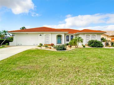 Single-story home with terracotta roof and well-manicured lawn at 3723 Toulouse Ct, Punta Gorda, FL 33950