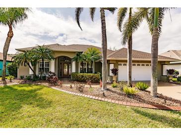 Single-story house with a landscaped yard and palm trees at 254 Rotonda E Blvd, Rotonda West, FL 33947