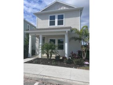 Two-story house with light gray siding, two-car garage, and small front yard at 164 Eagleston Ln, Lakewood Rch, FL 34240