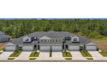 Townhome exterior with gray siding and white trim at 7610 Sea Oak Ct, Parrish, FL 34219