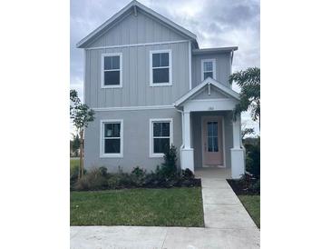 Two-story house with gray siding, landscaped lawn, and walkway at 180 Eagleston Ln, Lakewood Rch, FL 34240