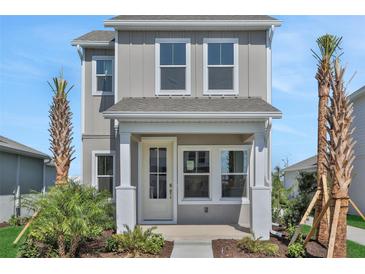 Charming two-story home with a welcoming front porch and well-maintained landscaping at 9019 Rothman Ln, Lakewood Ranch, FL 34240