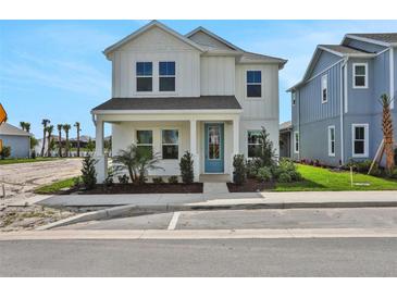 Charming two-story home boasts a welcoming porch and stylish blue front door at 196 Eagleston Ln, Lakewood Ranch, FL 34240