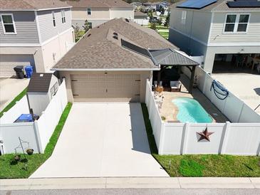 Aerial view of a single-Gathering home with a private pool, covered patio, and two car garage at 13003 Upward Pl, Riverview, FL 33579