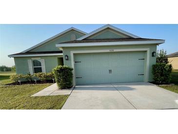 Charming single-story home with a well-maintained lawn and a two-car garage at 6698 Wirevine Dr, Brooksville, FL 34602