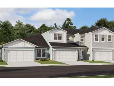 Charming townhome exterior with a two car garage and manicured landscaping at 7575 Sea Oak Ct, Parrish, FL 34219