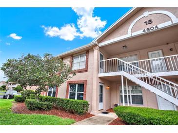 Charming condo with exterior staircase, tidy landscaping, and brick-accented facade at 4804 Myrtle Oak Dr # 11, New Port Richey, FL 34653