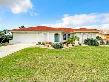Charming single-story home featuring a well-manicured lawn and a distinctive red tile roof at 3723 Toulouse Ct, Punta Gorda, FL 33950