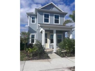 Charming two-story home with a covered front porch and well-maintained landscaping at 160 Eagleston Ln, Lakewood Ranch, FL 34240