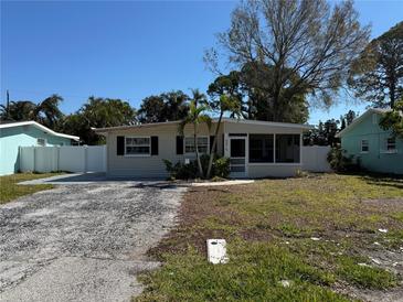 Charming single story home featuring a screened in porch, mature trees, and a spacious front yard at 9015 Bay Ne St, St Petersburg, FL 33702
