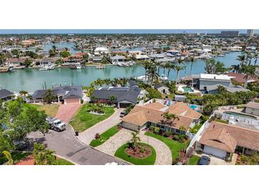 Stunning waterfront home with lush landscaping, circular driveway and serene water views at 1120 81St S St, St Petersburg, FL 33707