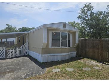 Cozy home with a covered entrance and a charming exterior design on a sunny day at 9202 Teak St, New Port Richey, FL 34654
