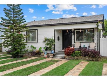 Charming home featuring a well-manicured lawn and inviting front porch at 4444 5Th S Ave, St Petersburg, FL 33711