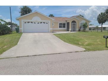 Charming single-story home featuring a two-car garage, well-kept lawn, and inviting curb appeal at 4611 Herman Cir, Port Charlotte, FL 33948