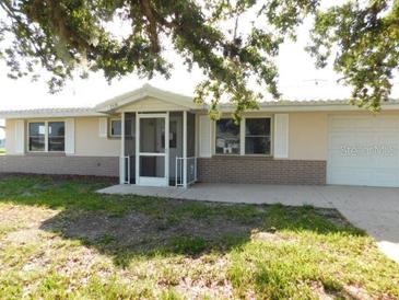 Charming single-story home with well-maintained lawn and inviting entryway with security doors at 3536 Harbor Blvd, Port Charlotte, FL 33952