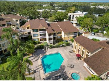 Condo building and community pool with lush landscaping at 1550 S Belcher Rd # 535, Clearwater, FL 33764